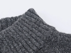 Macro detail of dark grey ribbed knit fabric with shiny silver lurex metallic threads