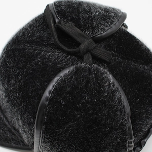 Detail of black faux mink fur trapper hat with leather piping and fabric ties for men