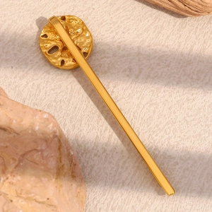 Macro view of minimalist 18K gold plated starfish hair clip with organic hammered texture