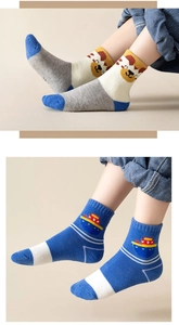 Detail view of thick knit cotton socks featuring cute cartoon animal and ship patterns