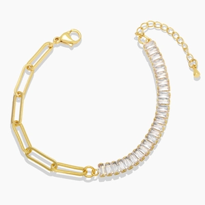 Gold paperclip chain bracelet with rectangular zircon stones on white background