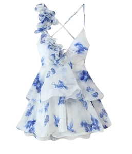 Detail of floral mini dress with 3D flower accent and layered ruffle skirt