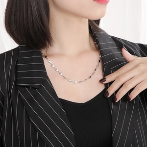Minimalist silver stainless steel heart link chain necklace shown on a model