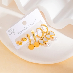 Detailed set of 3 gold stainless steel earrings with pearl bows and minimalist studs