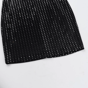 Detail of black velvet fabric with shimmering silver sequins on sexy bodycon party dress