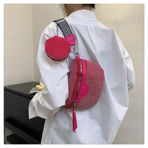 Pink studded crossbody saddle bag with a small coin purse and chain strap detail