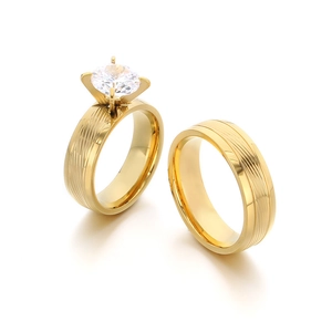 Polished gold stainless steel wedding ring set with sparkling round cubic zirconia