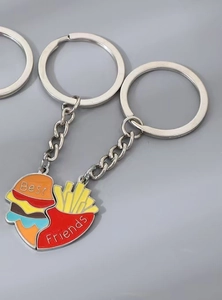 Detail view of heart-shaped Best Friends burger and fries enamel keychains set