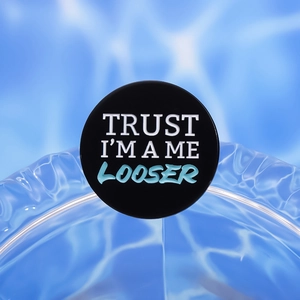 Trust Me I'm A Loser round metal badge with white text on black background for accessories