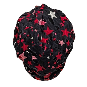 Detail of black knit beanie with colorful stars and distressed punk style cutouts