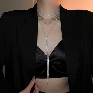 Detail view of multi-layered silver rhinestone fringe necklace on a black suit blazer
