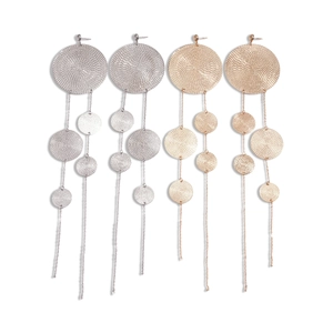 Exaggerated metallic round textured earrings with long tassels in gold and silver finish