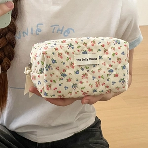 Quilted corduroy floral makeup bag with elegant flower print and secure zipper closure