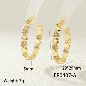 Detail view of 29mm gold chain hoop earrings with cubic zirconia flowers and bear motifs