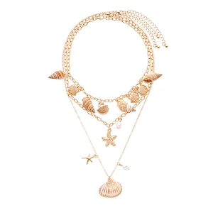 Bohemian gold layered necklace with sea shells, starfish pendants and pearl charms