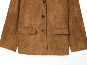 Detail view of brown faux suede blazer featuring symmetrical flap pockets and black buttons