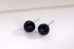Macro view of black faceted crystal sphere stud earrings with S925 silver posts