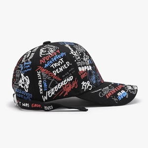 Black baseball cap with colorful all-over graffiti text and side webbing detail