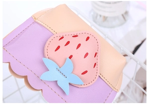 Detail of strawberry coin purse showing macaron color stitching and fine PU leather texture