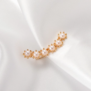 Detailed view of elegant gold-plated ear cuff featuring six delicate white pearls