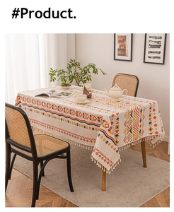 Detail of bohemian linen tablecloth featuring ethnic geometric patterns and white cotton tassels