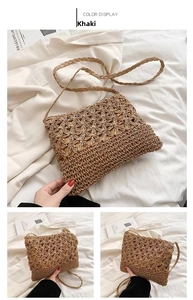 Detail of khaki woven straw bag with hollow floral pattern and braided shoulder strap