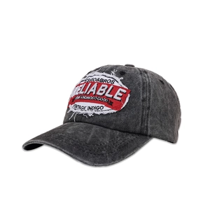 Detail of embroidered patch on vintage washed cotton baseball cap showing Reliable text