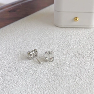 Detail of 925 sterling silver earrings featuring rectangular cubic zirconia in prong setting