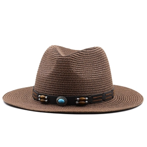 Close-up of brown straw cowboy hat with turquoise gemstone and wooden bead hatband