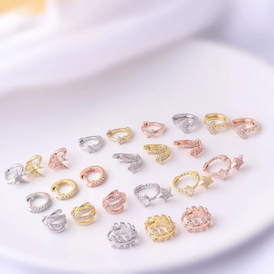 Geometric micro-pave zircon cartilage earrings in gold and silver plating on white tray
