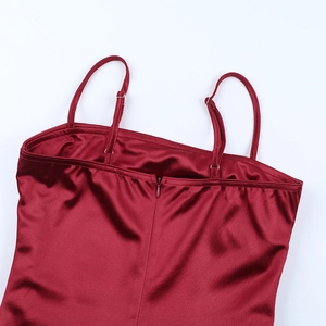Detail of burgundy satin dress showing adjustable straps and invisible back zipper