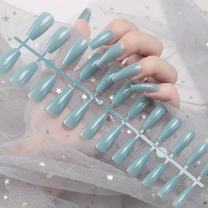 Detail of Morandi blue coffin nails set with 24 pieces in glossy finish on grey mesh