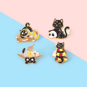 Set of four magical black cat enamel pins featuring starry patterns and golden metal details
