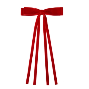 Detailed view of luxury red velvet bow hair clip with long elegant streamers on white background