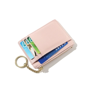 Detailed view of pink textured leather card holder with zip pocket and gold keychain