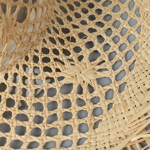 Macro detail of hand-woven hollow mesh pattern on natural raffia straw sun hat