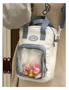 White and gray crossbody ita bag featuring a clear PVC window for display