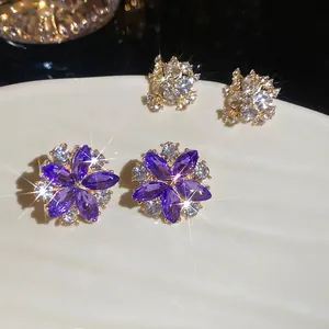 Elegant floral silver needle earrings with purple crystals and sparkling zircons set in gold