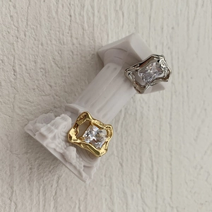 Vintage style square zircon rings with irregular gold and silver lava frames on white columns