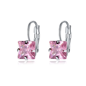 Detailed macro view of silver hoop earrings featuring square pink zircon gemstones