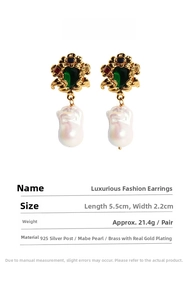 Detail view of Baroque vine emerald earrings with multi-color stones and Mabe pearls
