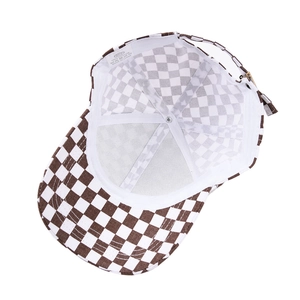 Detailed interior view of checkered baseball cap showing cotton lining and metal buckle