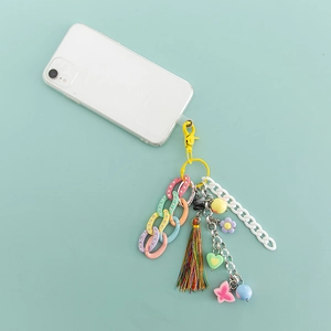 Detail of colorful acrylic phone strap with heart, flower, and tassel charms