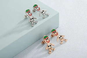 Detail of whimsical cartoon character stud earrings in silver and rose gold finish