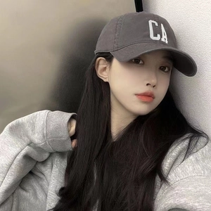 Charcoal grey baseball cap with white CA embroidery on front, worn by a model in casual style
