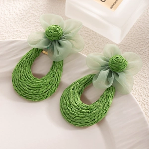 Handmade raffia flower earrings in light green mesh with a bohemian chic aesthetic