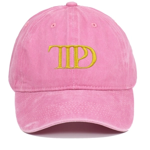 Close-up of pink washed cotton baseball cap with yellow TTPD letter embroidery texture