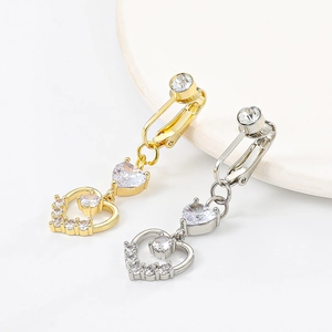 Detail view of heart-shaped clip-on earrings with crystals in gold and silver plating