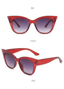 Detail of red translucent cat-eye sunglasses with gradient purple lenses and metal accents