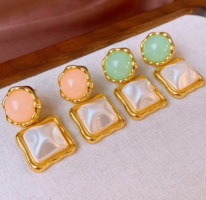 Detailed close-up of retro resin square drop earrings with pearls and gold metal plating
